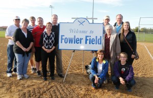 The Fowler family  thanks the Fowler Field sign, on the left: brother-in-law Rich Knorr, sister Brenda, son Ryan, son Andy, wife Linda, Steve. On the right, back row, father Harry, brother Chuck; middle row: mother Margarite, niece Becky Knorr; front row: sister-in-law Joanie Fowler and niece Jessica Fowler.