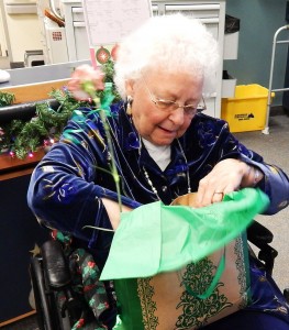 Beikirch resident Ruth Langdon opens a gift presented by the Brockport Auxiliary Service Corporation (BASC) on December 18.