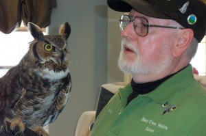 Wildlife rehabilitator Gary Zimmerman holds a horned owl during a program at Westwood Commons.