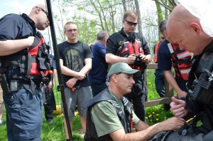 New Visions student Ken Toepper listens as Monroe County Sheriff’s Deputies prepare the diver for the search.