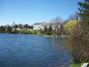 A view across Mirror Lake in Delaware Park in Buffalo looking at the Japanese Garden and the Buffalo History Museum.