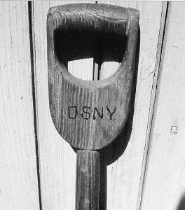 The handle of a scoop shovel we still use, with its origin clearly visible.