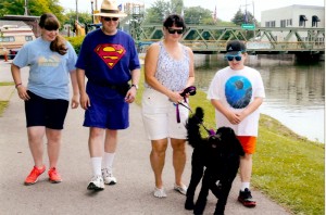 The Sarnov family enjoys a walk on the Erie Canalway Trail in Spencerport. The Hilton group consists of Hannah, 12, Mark, Bobbi and Nathan, 10. The goldendoodle is Gwen, a two-year-old and the 13th pup in a litter of 13, that was featured in a group picture in the Suburban News and Hamlin-Clarkson Herald two years ago.