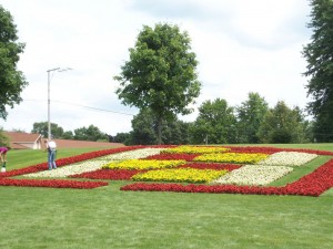 Workers in The Quilt Garden provide a sense of perspective to show the size of the design.