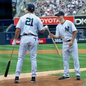 Yankee batboy Aaron Patella Ryan hands a bat to former Yankee player Paul O’Neill during this year’s Old Timers’ Day. 