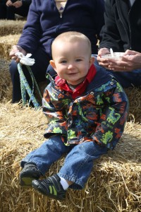 Hilton resident Jacob Merrill, 1, was enjoying the music of Mike Kornrich in the Kid’s Corner at Hilton Apple Fest. He was resting after previously dancing to the rhythm of Mike’s playing.