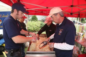 Members of the Knights of Columbus from St. Leo Church in Hilton are busy bagging the very popular treat they were selling, Kettle Korn, at their new location south of the gazebo at the Apple Fest. 