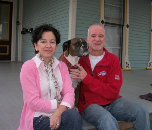 Valerie Ciciotti and Kevin McCarthy sit on the porch steps of 41 Park Avenue in Brockport with their dog, Bella. The couple owns the home and rent it to college students. Kevin spent the last four years painting the exterior, suffering a life-threatening fall in the process. Valerie picked out the color-scheme and Kevin says Bella was a faithful companion throughout the project. 