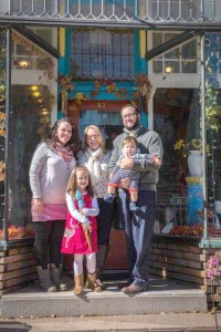 Chris McEntee, previous owner of Splatters Studio in Spencerport village, with new-owner Dan McCollester and family.
