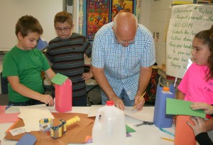 Larry Dabney helps the students create their containers.