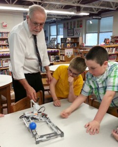 Mentor Frank Rakoski helps students Jacob Thomas (middle) and Hayden Watt to operate a robot display in the robotics lab. They were part of break-out sessions following an overview of the Hill School’s 2014-15 Academically Talented Program. Enrichment specialist Buck Noble led the presentation to parents and interested others at Hill School on May 5.  Photo by Dianne Hickerson