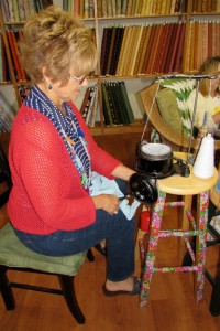 Carol Gursslin explains how the sock knitting machine works to other knitters in the group. K. Gabalski photos