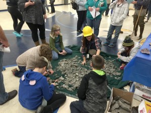 Earth Science teacher Kelly Smith helps students look for fossils. Provided photo 