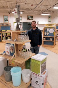 Brockport Country Max store manager Josh Forbes stands next to equipment and books available for those who want to try tapping their own maple trees to make maple syrup. K. Gabalski photo