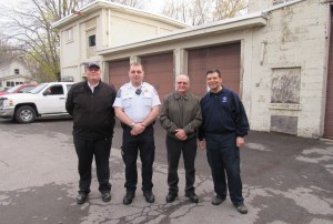  Cody Dean, past chief Brockport Volunteer Ambulance Corps; Colin Arthur, BVA Chief of Operations; Marv Duryea and David Rice, BVA president (l-r), pose outside the building, which is in the process of becoming the new home of Brockport Volunteer Ambulance. Cody Dean says a fresh coat of paint will be the first order of business.  K. Gabalski photo