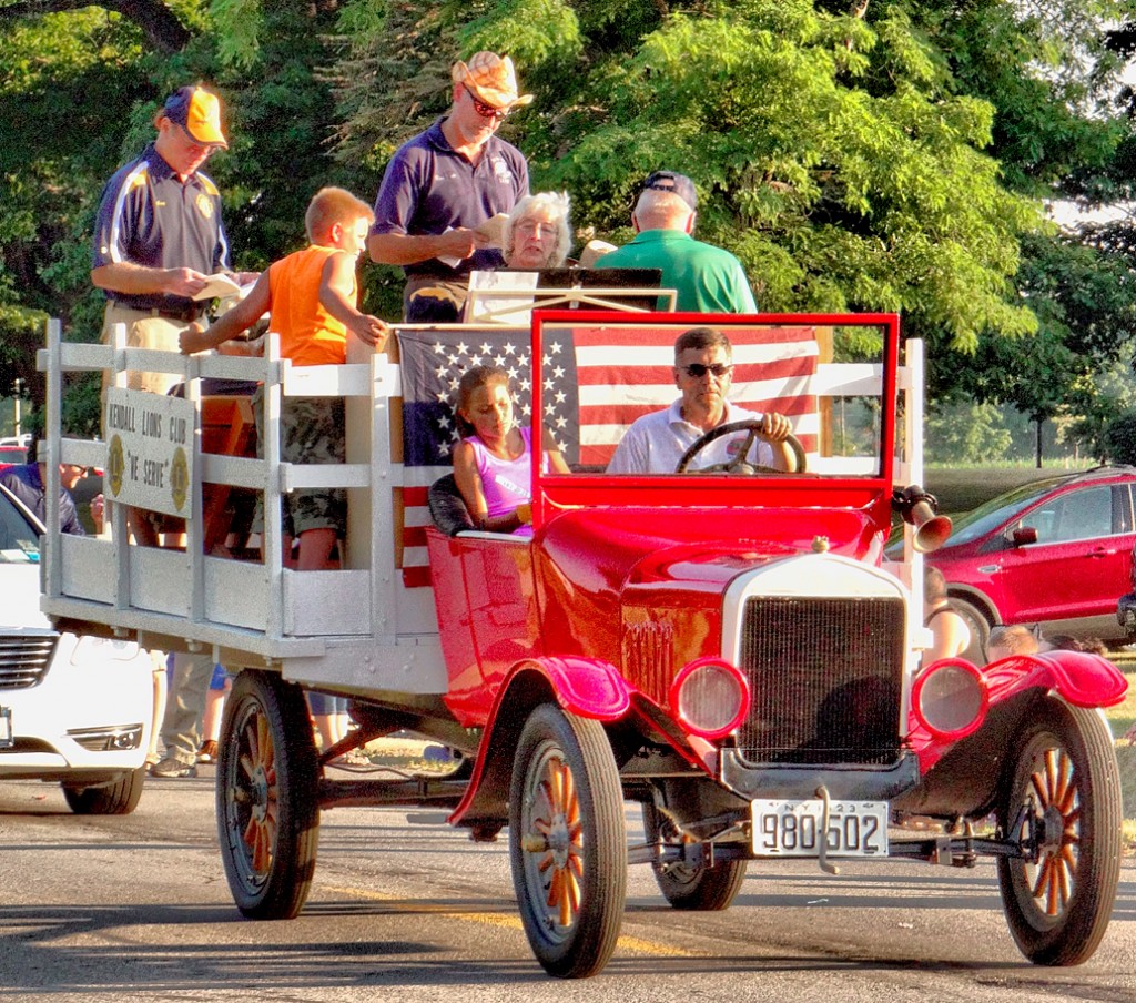 The Kendall Lions Club rode through the Kendall Parade in an old classic while singing along to festival tunes.