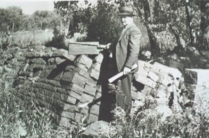 A photograph of Pasquale DiLaura standing with Medina sandstone from the Clarendon quarry.