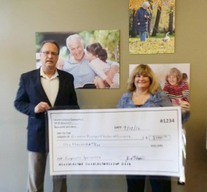 Jim Payne (left), Director of Marketing, Seniors’ Choice Communities hands a corporate sponsor check to Robin Waller, President of the Greater Brockport Chamber of Commerce for the organization’s Casino Night event on October 7. Provided photo