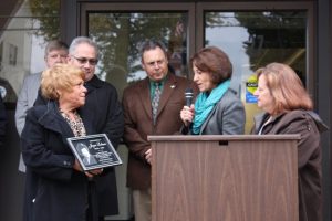Pictured left to right: Mary, Mike and Jim Lobene accept the plaque from Canal Days Committee members Becky Daniels and Alba Alonci. Photo by Maggie Fitzgibbon