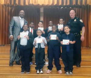 Lt. Cuzzupoli and the founder Mr. Burnice Green Sr. with the boys from the program. Provided photo