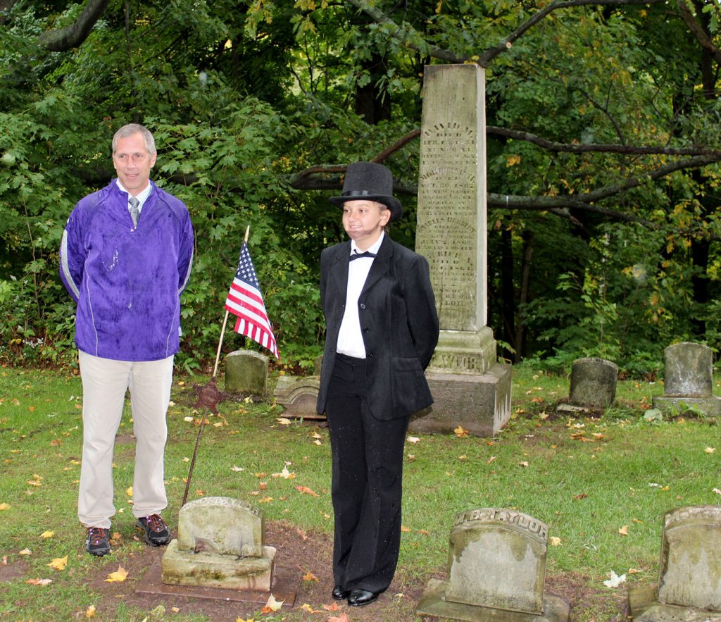 Tim Archer poses with Albion 8th grader Emily Mergler who dressed as President Abraham Lincoln. Students read Lincoln’s Gettysburg Address during the ceremonies. Provided photo