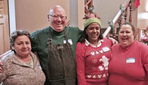 Taking a moment off from working on the Christmas party for migrant farmworker families are: (l to r) Doris Valentin, Bill Plews, Irene Sanchez and Ann Jasmin. The party was held at The Center on State Street in Brockport on Saturday, December 10.  Photo by Dianne Hickerson