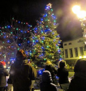 Members of the Holley community watch as the tree is lit in the Public Square. Prior to the lighting, Mayor Brian Sorochty read names of those remembered with “Memory Bulbs.” K. Gabalski photo