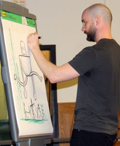 Author/Illustrator Peter Brown draws The Wild Robot for students at Quest Elementary School in Hilton. Provided photo