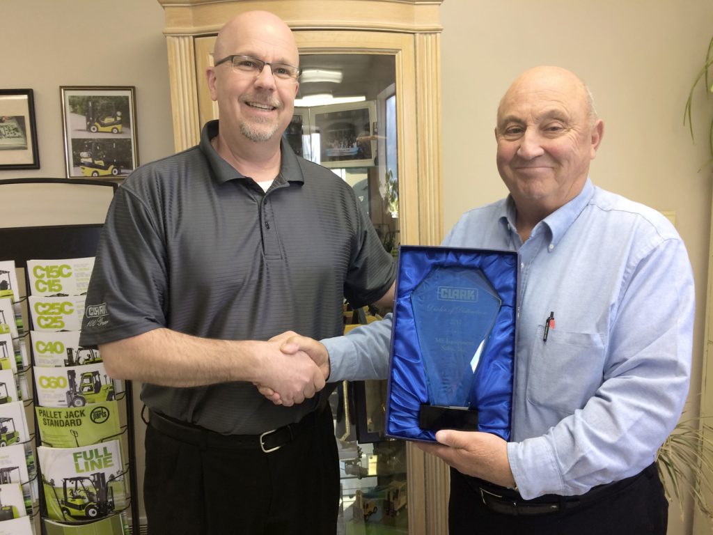 Andy Jurginson, Northeast Regional Coordinator of Clark Material Handling (left), presents Mike Scamacca, President/CEO of MS Equipment, with the Dealer of Distinction Award. Provided photo