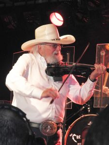 Charlie Daniels plays the fiddle. 