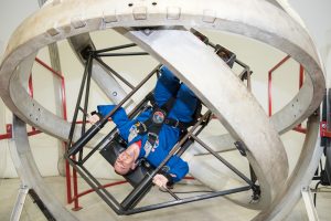 Hilton’s Stephen Cudzilo, an eighth grade earth science teacher, experiences the multi-access trainer, which simulates the disorientation one would feel in a tumble spin during reentry into the Earth’s atmosphere. Provided photo