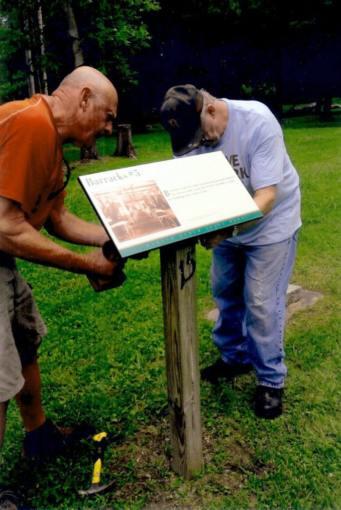 Friends of Hamlin Beach members, Jim Lugert (left) and Ralph Preston secure a sign to a post. Provided photo