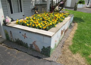 The garden is filled with marigolds ... Karen says she will plant it with annuals so she can change it from year to year ... the front also includes a crescent moon and stars which glow at night. K. Gabalski photo