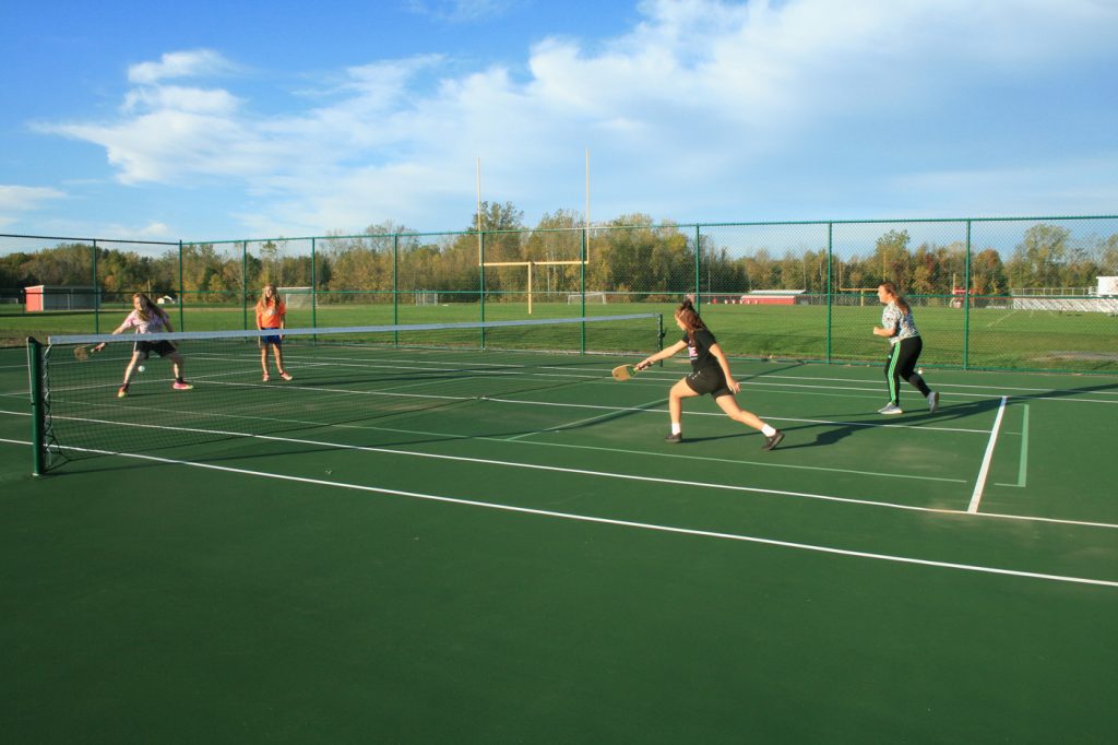 Students demonstrate how to play pickleball on the repurposed tennis court. Provided photo