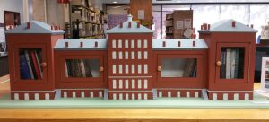 The Normal School Little Free Library as it appears on display at the Drake Memorial Library at the College at Brockport. It will eventually be mounted outside the Alumni House which is in front of Hartwell Hall on the campus. The model is 67 inches long, 22 inches high to the peak of the roof, and 12 inches deep. Photo by Dianne Hickerson