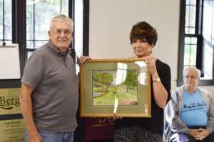  Ed Adams with Mayor Anna Marie Barclay presenting a painting he had done of Hartland Park to the Pavilion. Sage Pavilion is located in Hartland Park. Photo by Rick Nicholson