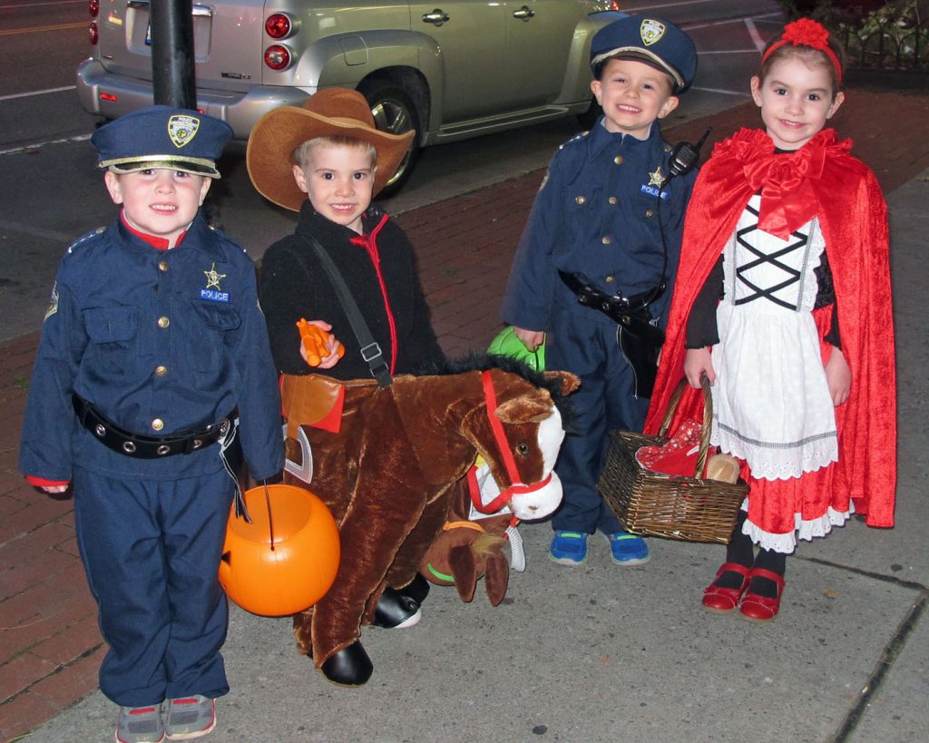 What it’s all about - a group of unidentified children shown below enjoying Halloween (and showing off their costumes for the camera). 