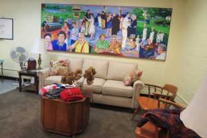 A sitting area with comfortable furniture, area rug and a mural moved from the Lodge on the Canal make up a corner of the new gathering/activity room at the Sweden Clarkson Community Center. K. Gabalski photo