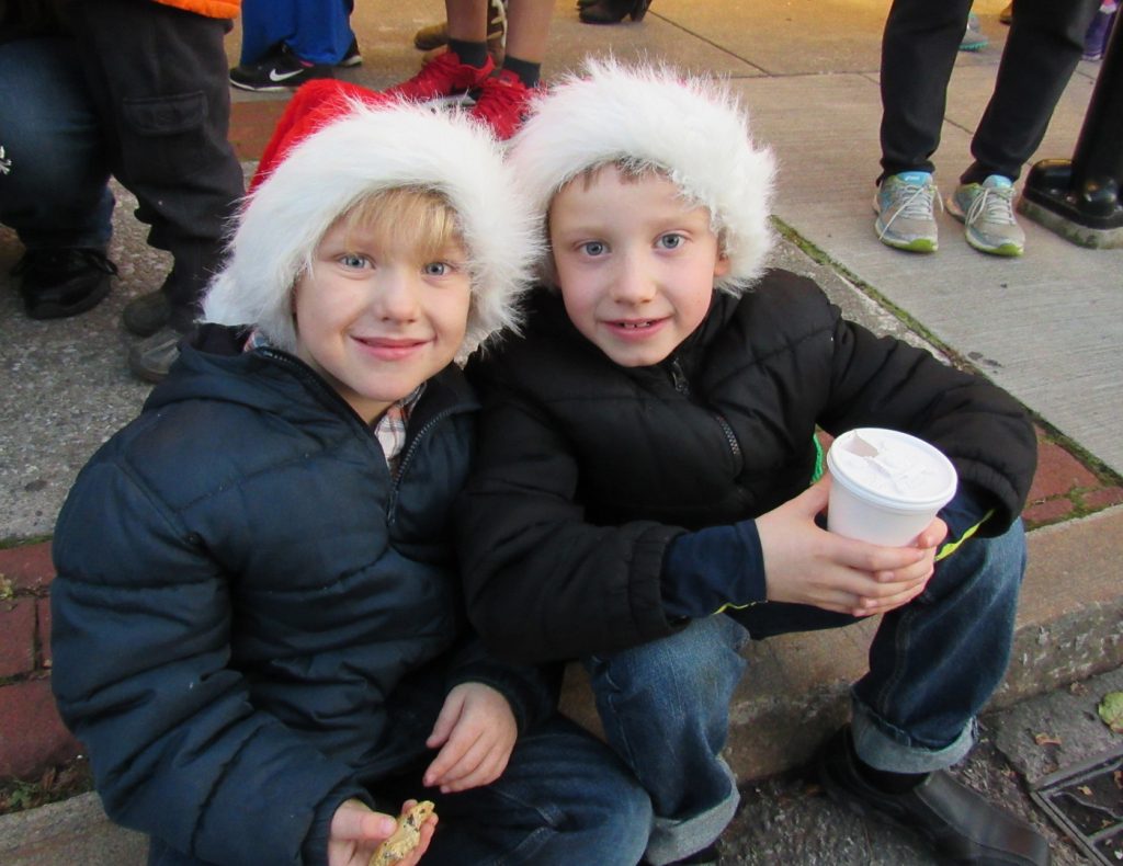 Crosby and Quinn Christy - ages 6 and 8 - of Brockport, enjoy refreshments prior to the start of the parade. Their family said they were having fun while an older sibling sang Christmas Carols nearby. K. Gabalski photo