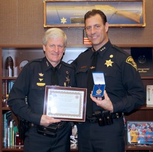 Undersheriff Andrew Forsythe receives Purple Heart medal from Sheriff Patrick O’Flynn. Provided photo