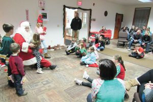 Santa listens to Christmas wishes from young participants during the “Umpteenth” Holiday Party in Clarkson. K. Gabalski photo