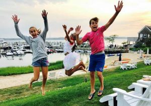 Margaux, Madisen and Colin jumped for joy as they watched the sunset together near the MacKinnon’s beach house. Provided photo.