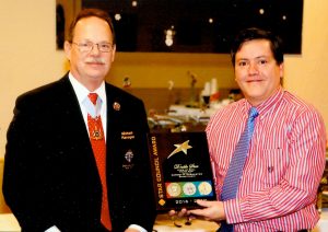New York State advocate Mike Flanagan (left) presents the “Double Star Council Award” to Grand Knight Jose Rivera.