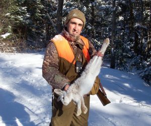 Phil Milici with a stunning snowshoe hare he harvested in the deep snows of the Tug Hill region. Provided photo