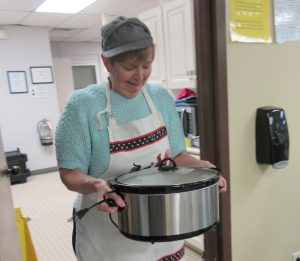 Betty Coopenberg delivers “hot” soup to the dining area. Provided photo