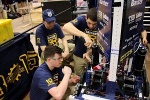 Members of Spencerport’s Team 3015 work on their robot. Provided photo