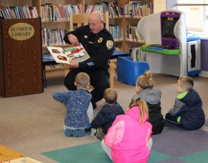 Chief Mark Cuzzupoli reading to children at the Syemour Library during the Brockport Kiwanis Club’s “Reading Rocks!” event in March. Provided photo
