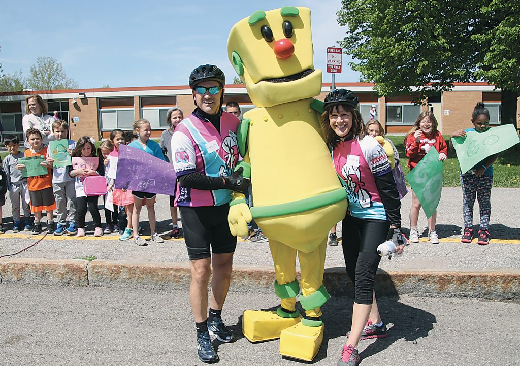 Members of the Spencerport Ranger Riders, Gregory Kincaid and Christine Kincaid, took a moment to pose with Clicky the spokes-robot at a stop in Spencerport. Provided photo