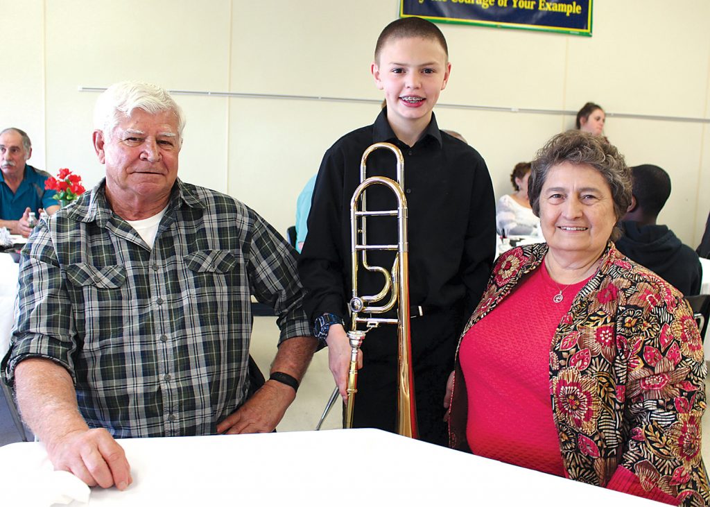 Will Green, a seventh grader at Merton Williams Middle School in Hilton, greets his grandparents, Ed and Sherry Schaus, after playing with the jazz band during the annual Grandfriends Breakfast. Provided photo.