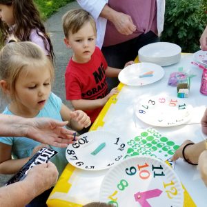 The MOMS club of Brockport helped children make their own clocks. 